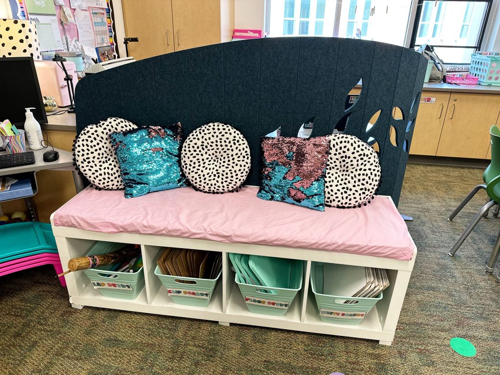 Bench with pink pillow and room divider for flexible seating
